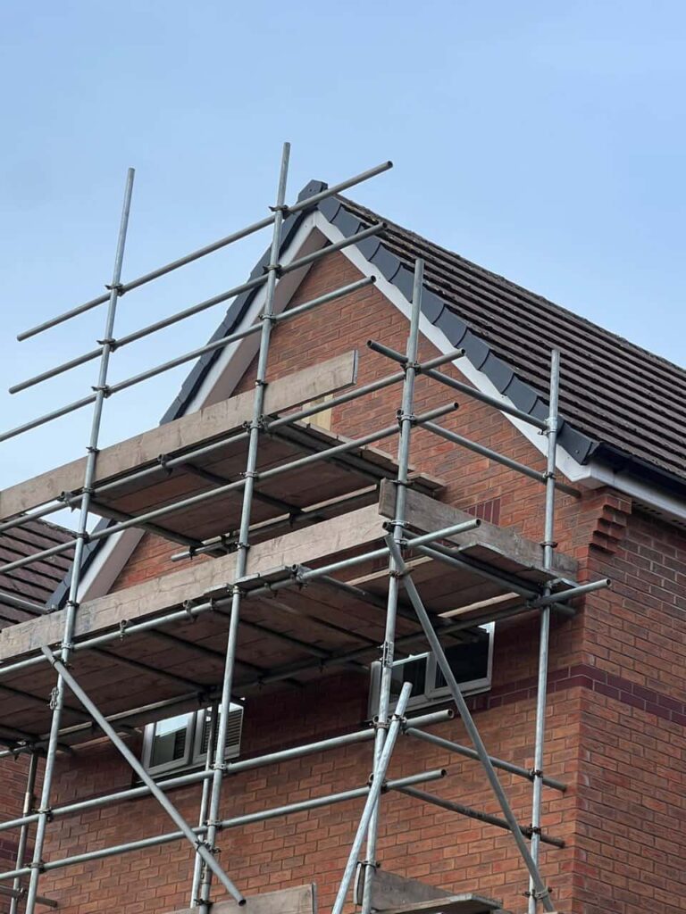 This is a photo of a roof which has just been repaired. There is a scaffold located at the gable end for access onto the roof. Works carried out by LS Roofing Hazlemere